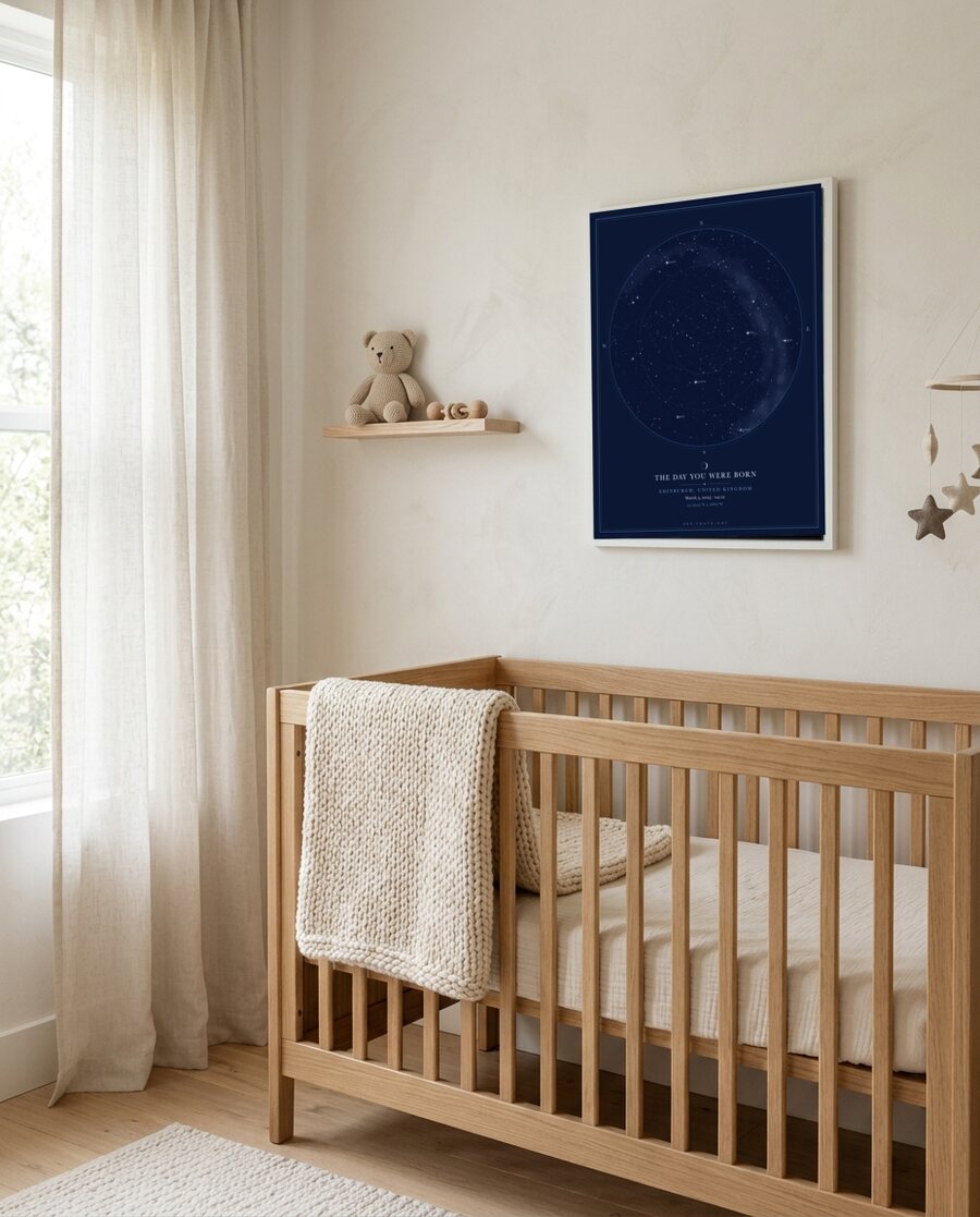 Framed star map above a crib in a nursery