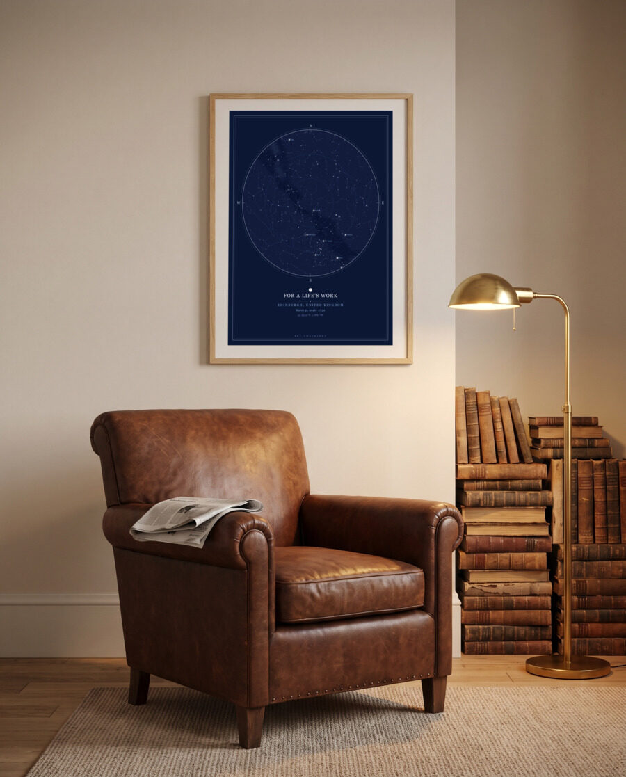 Framed star map in a study above a leather reading chair